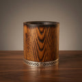 Charred oak bourbon tumbler handcrafted from natural wood on a warm wooden surface.