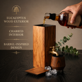 Eucalyptus wood whiskey dispenser with brass faucet, lacquered exterior, and charred interior
