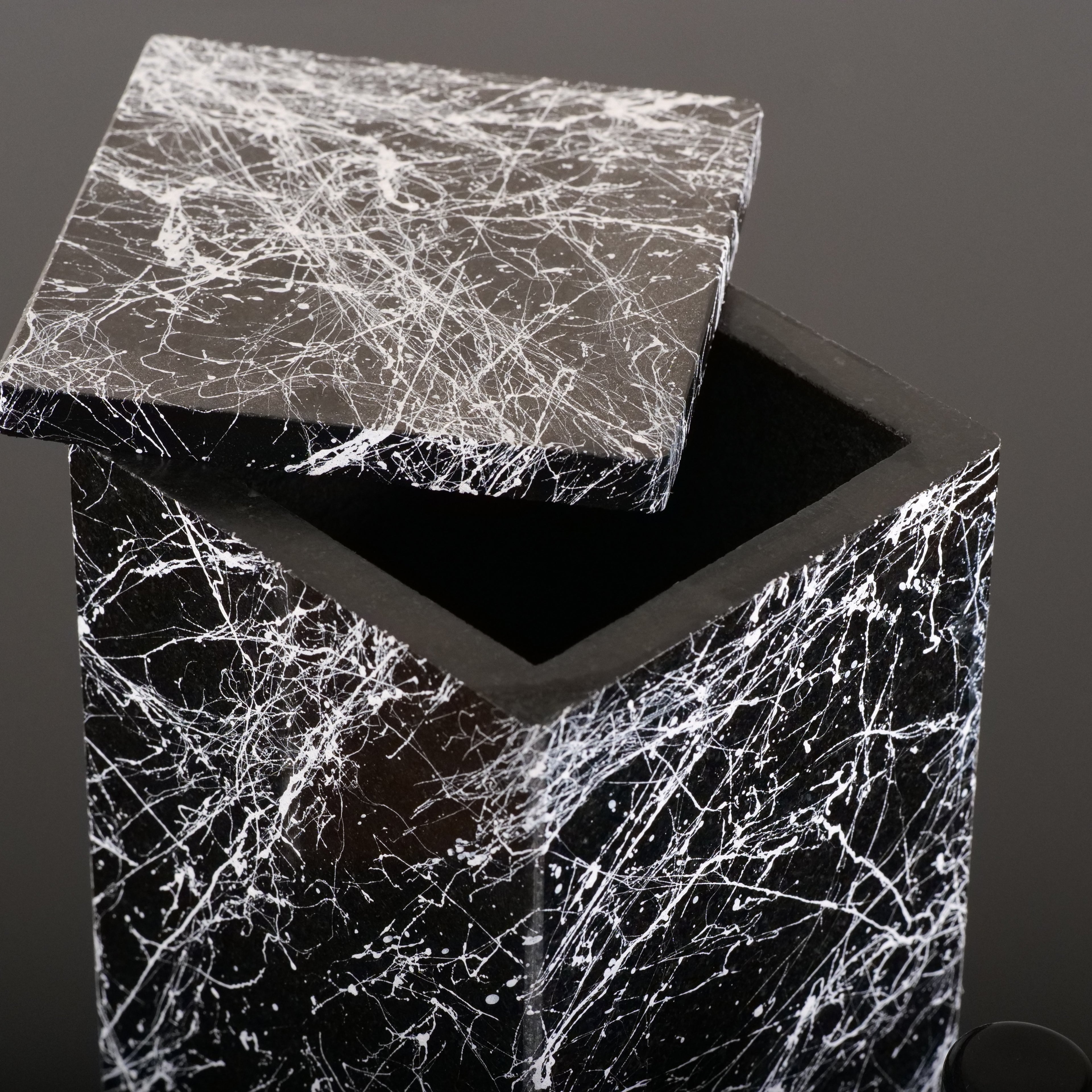Black granite beverage dispenser with removable stone top cover opened for filling