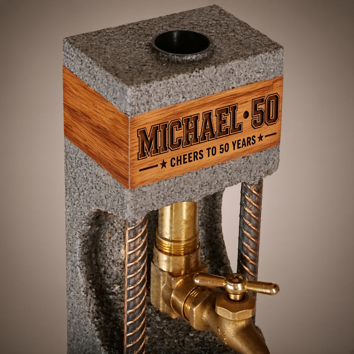 Close-up of custom engraving on the oak band of a concrete whiskey dispenser