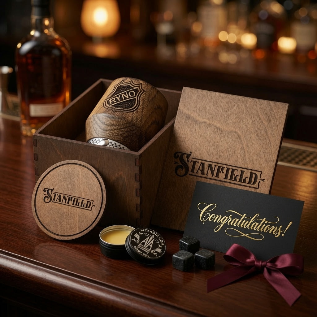 Open wooden whiskey gift box with engraved oak tumbler, coaster and three whiskey stones