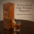 Personalized oak whiskey dispenser with brass faucet and engraved monogram, shown with a whiskey glass, highlighting the charred oak interior.