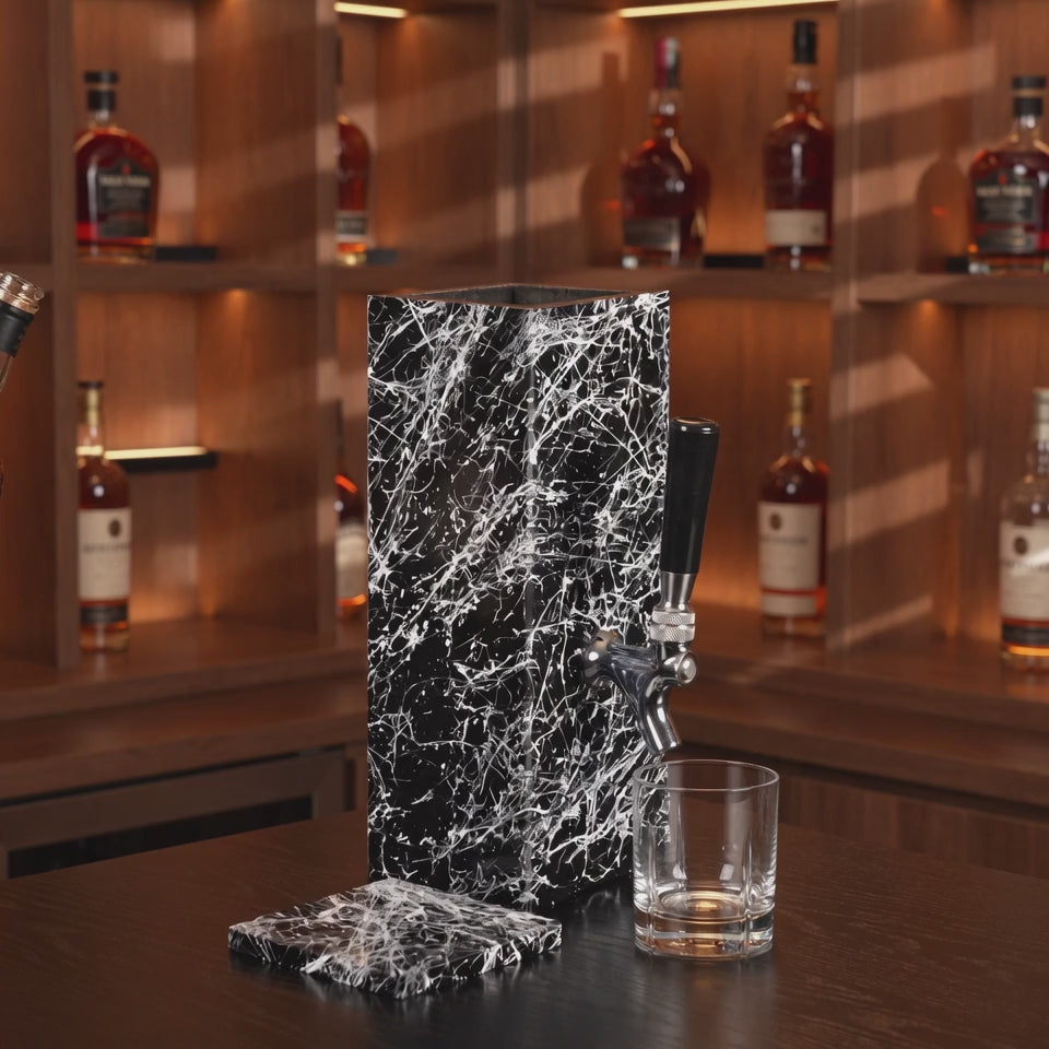 Black granite beverage dispenser lifestyle video in a warm modern whiskey bar setting