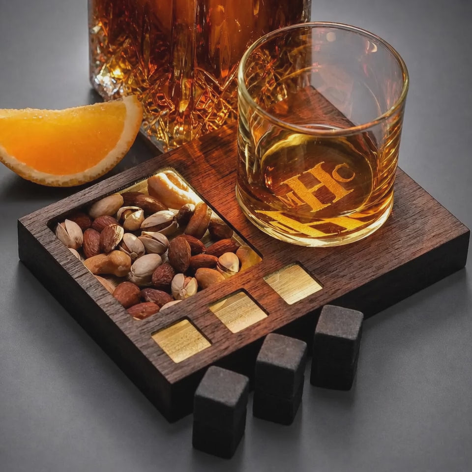 Video showing personalized LED whiskey glass set with illuminated wooden snack tray and glowing engraved glass.