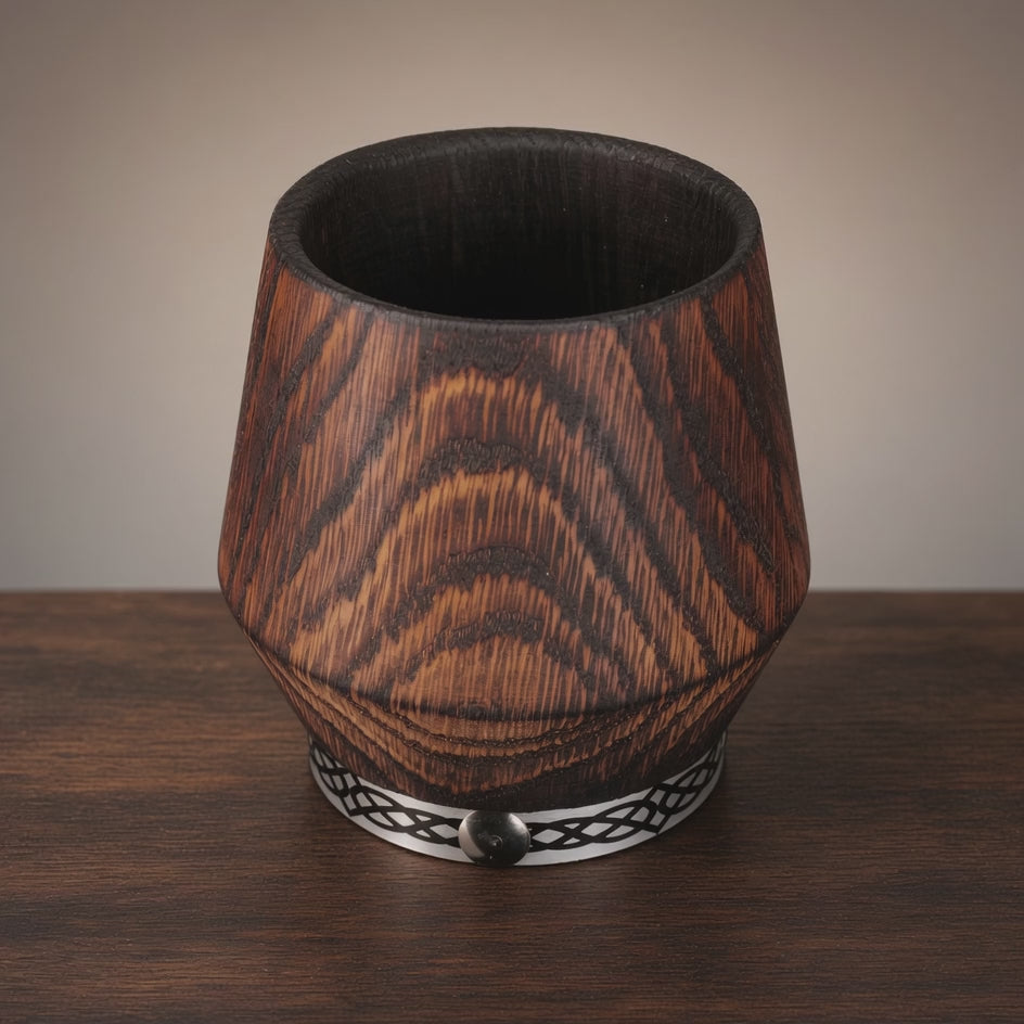 Rotating view of a handcrafted charred oak whiskey tumbler with natural wood grain and a decorative metal band