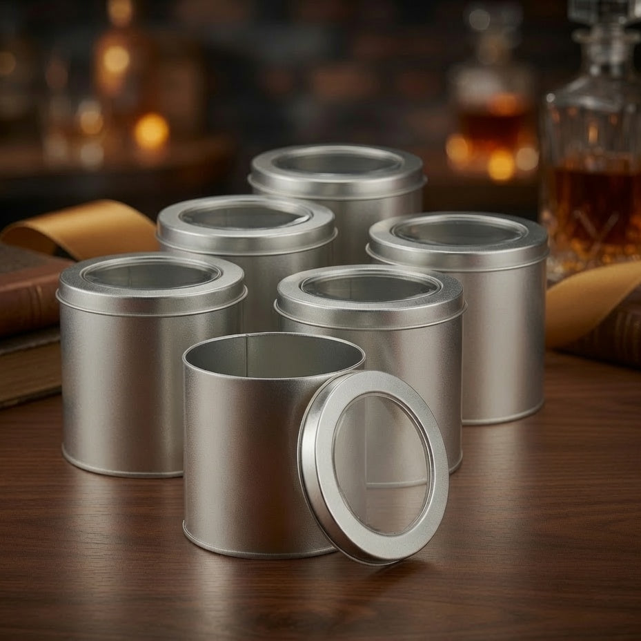 Several round silver metal gift boxes with removable clear window lids