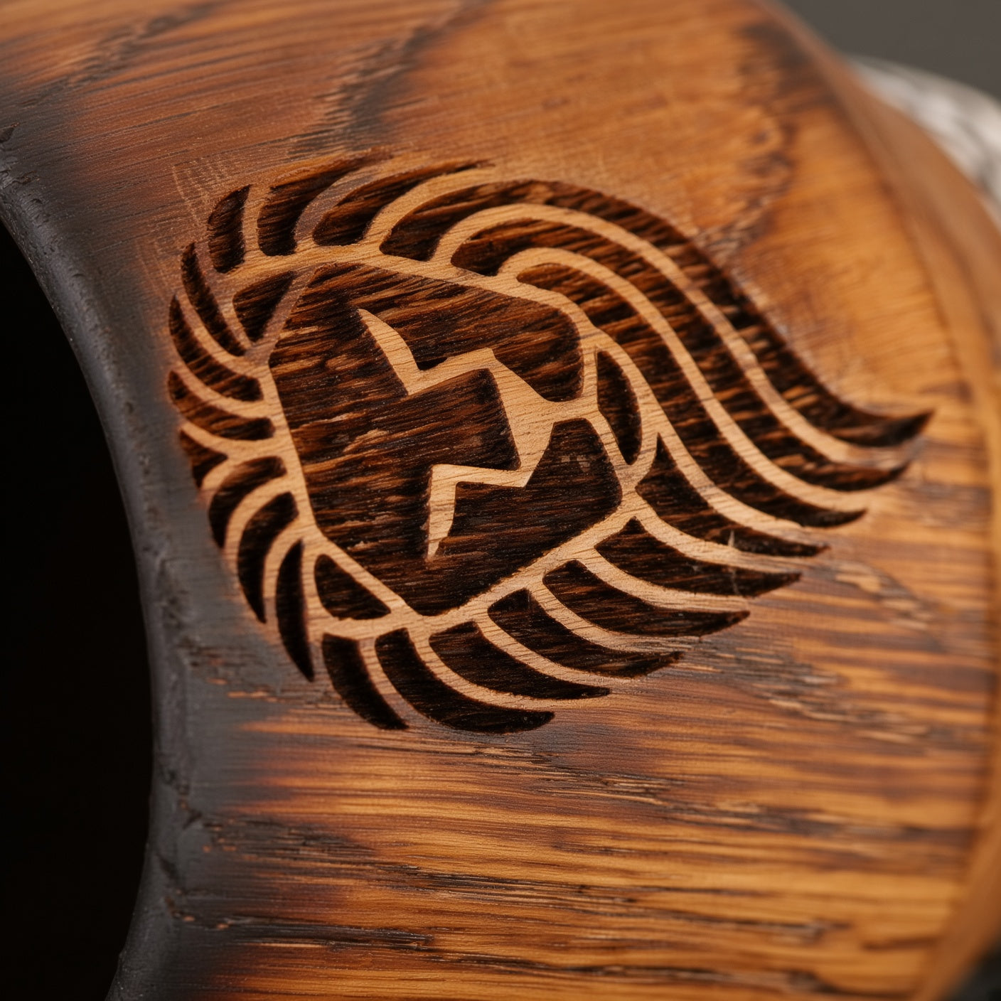 Close-up of lion engraving on a handcrafted charred oak whiskey smoker glass.