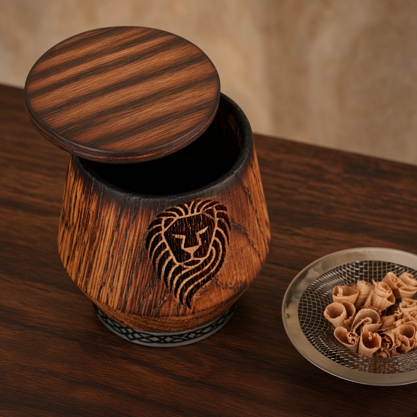 Studio view of engraved oak whiskey smoker kit with lion design, wooden lid, and oak smoking chips.